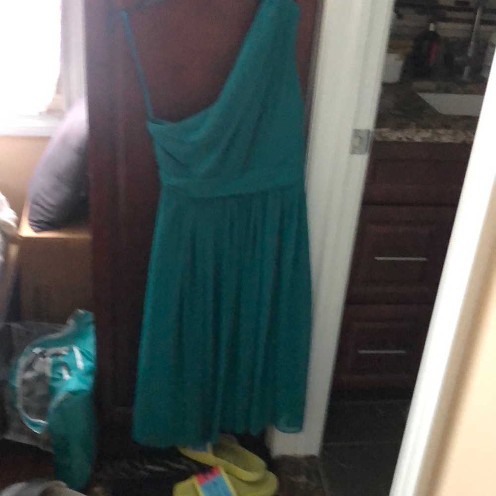 It is a green asymmetrical dress